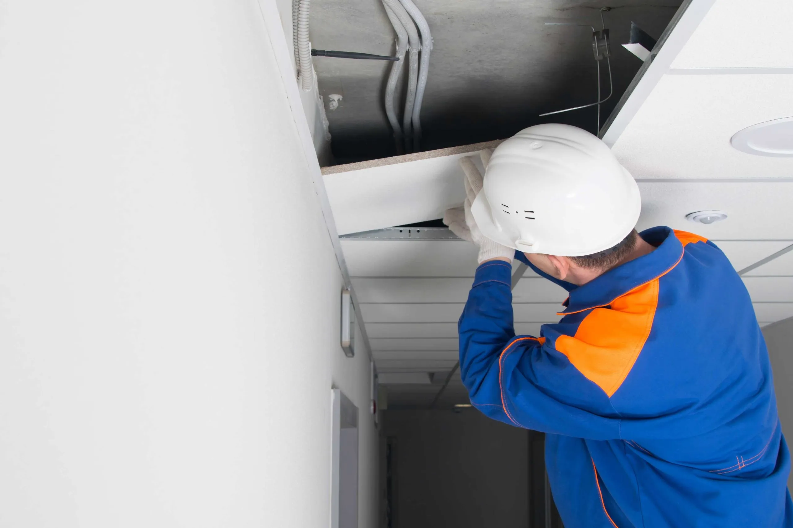 An Embarq maintenance technician servicing building plant equipment