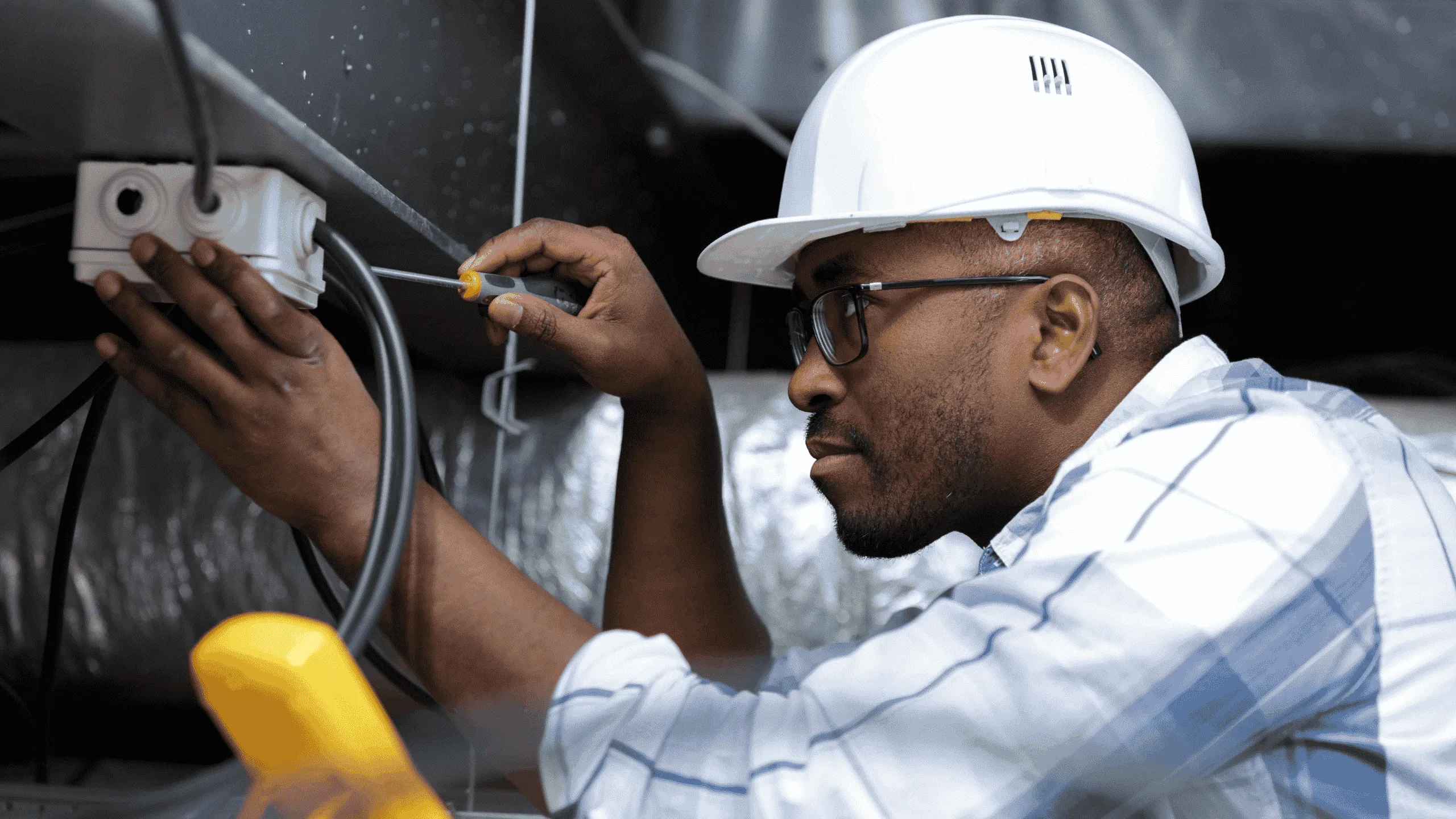 A commercial electrician working on a distribution panel